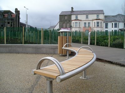Shoreline SL008 bench and CL052 litterbin. Made from Iroko timber and 316 stainless steel. From our Shoreline street furniture range