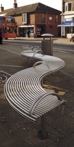 Curved bench with armrest