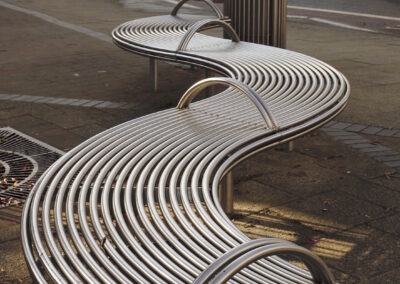 Curved bench with armrest