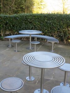curved bench with stools and table