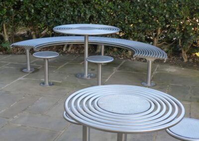 curved bench with stools and table