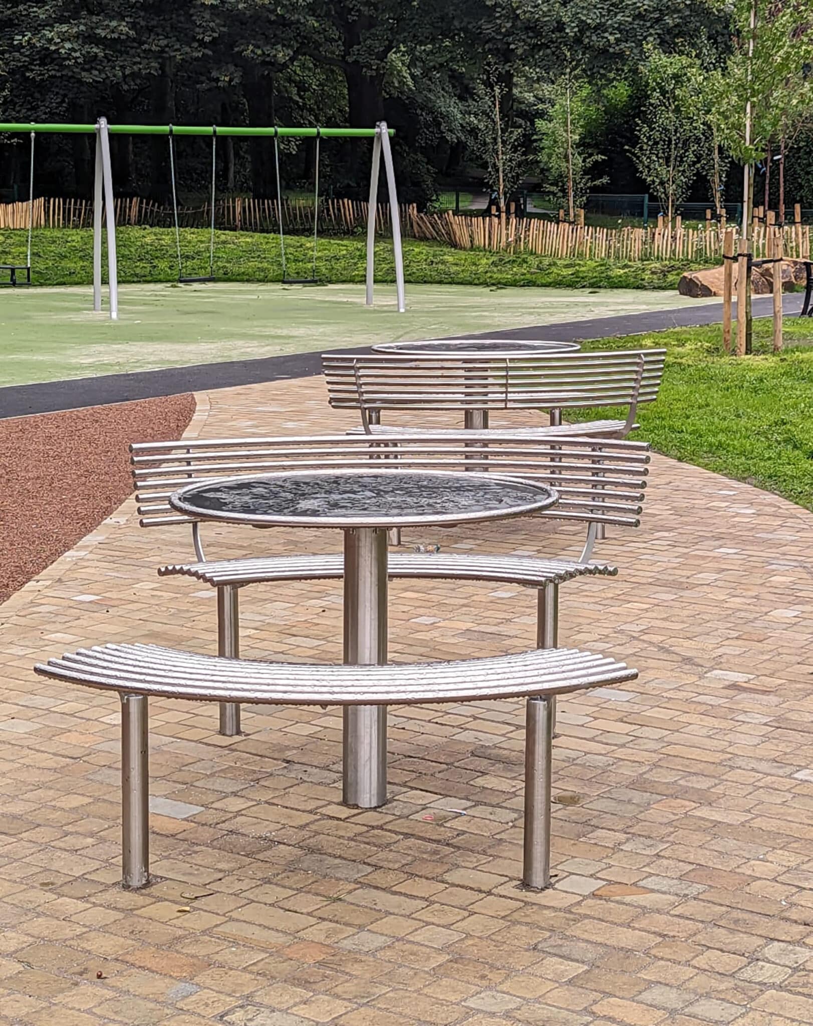 Round picnic table with curved seat and bench